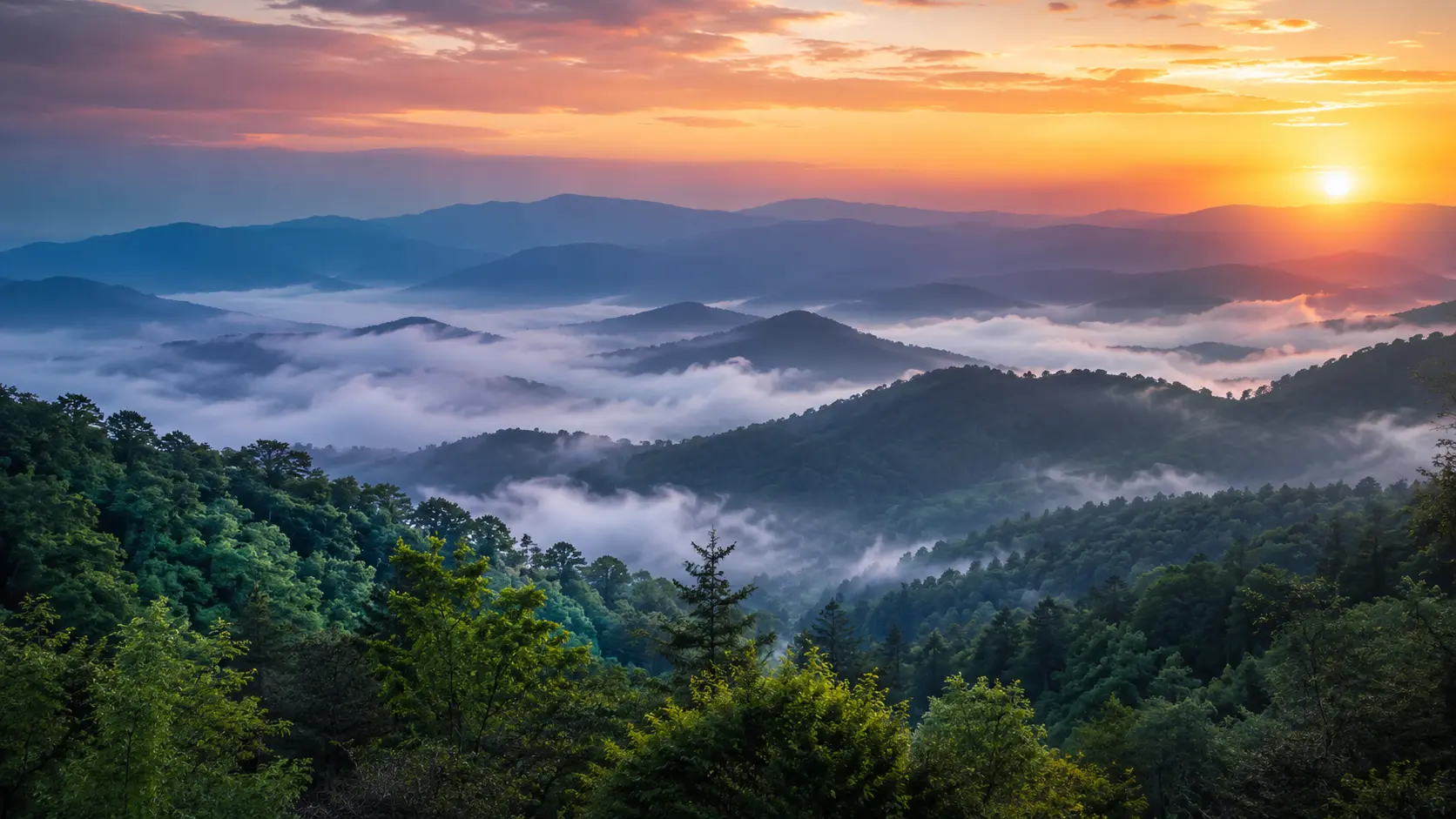Mist settling over forested Smoky Mountain ridges at sunrise