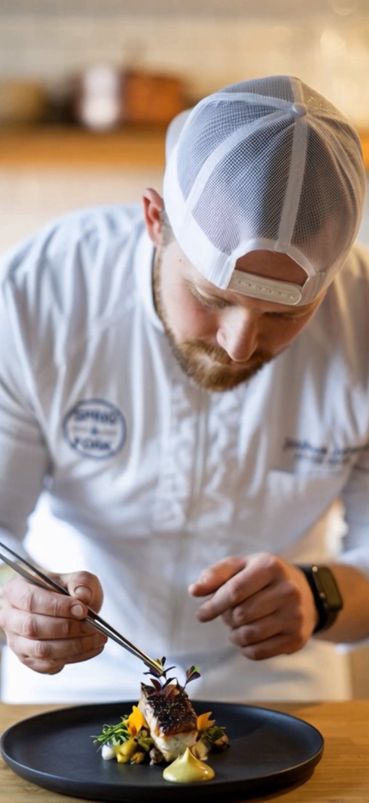 Chef Joshua Jones plating a course in a Nashville kitchen